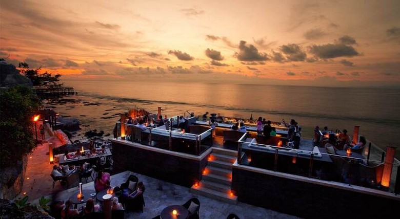 Bàn ăn hải sản bãi biển Jimbaran lúc hoàng hôn, nến lung linh, sóng biển phía sau